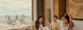 Family relaxing in a suite at Banyan Tree Bangkok