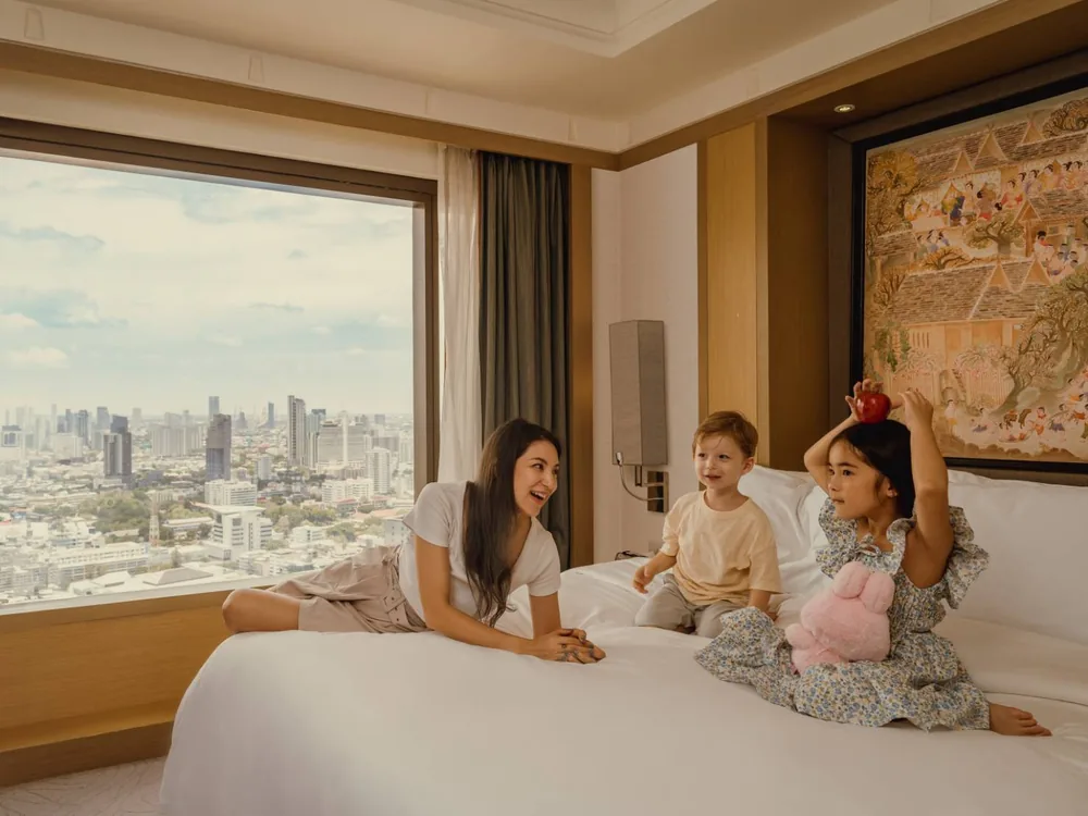 Family relaxing in a suite at Banyan Tree Bangkok